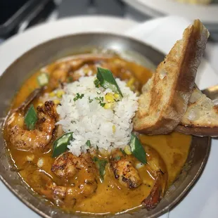 a plate of food with rice and bread