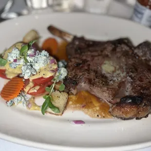 a plate of steak and vegetables