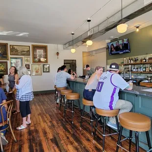 a group of people sitting at a bar