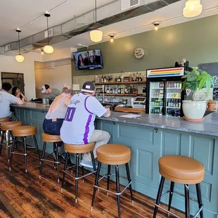 a group of people sitting at a bar