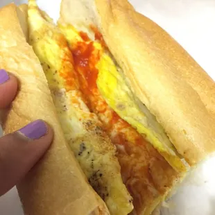 Egg and cheese with hot sauce on a roll. Delicious! Large portion for $2.50