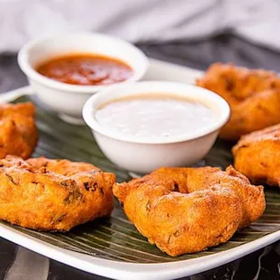 a plate of food with dipping sauce