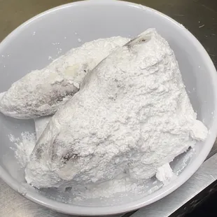 a bowl of powdered doughnuts