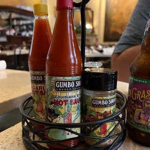 Gumbo Shop hot sauce, garlic sauce, and perfect pepper blend