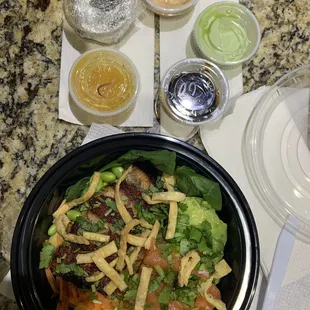 2 Proteins Poke Bowl - salmon and grilled eel plus a bunch of toppings; sauces top and clockwise: yum yum, sweet wasabi, eel, peach, ponzu