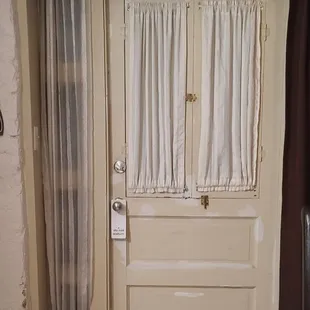 Door and wall need patching and painting.