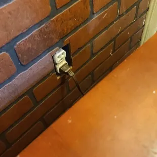 Plaster splatter on the wall and furniture. There is no plate over plug socket.  Sticky drink rings on nightstand.