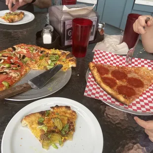 Small pizza half veggie half hamburger. In the side individual pepperoni slice.