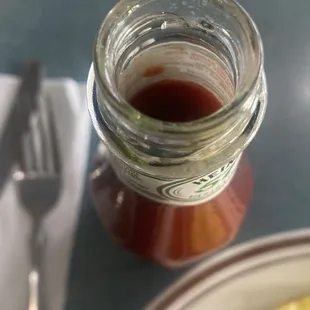 a plate of food and a jar of syrup