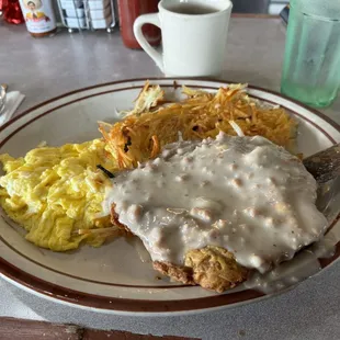 Chicken fried steak, scrambled eggs, and hash browns.