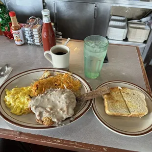 Chicken fried steak, scrambled eggs, sourdough toast, black coffee, water.