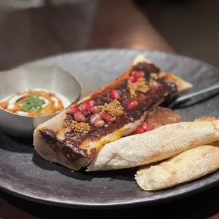Wood oven roasted bone marrow with pomegranate molasses and mustard seeds
