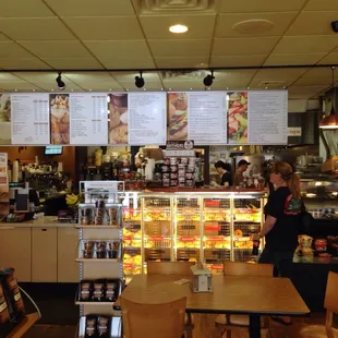 a woman standing in a bakery