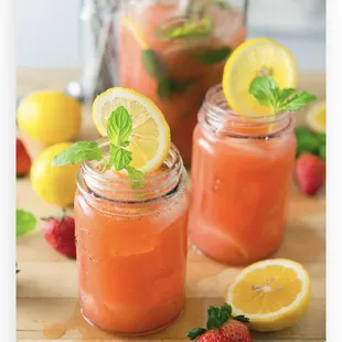 a close up of two jars of fruit juice