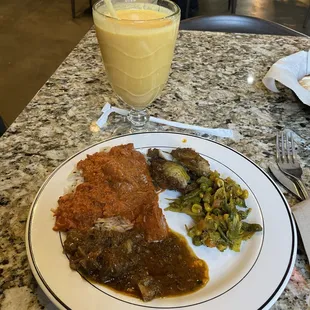 a plate of food and a glass of orange juice