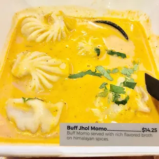 a bowl of soup with dumplings