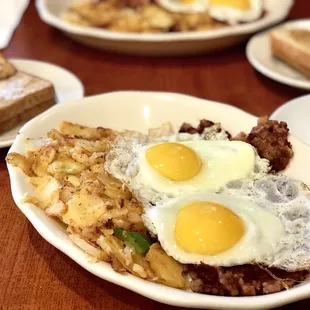 Two eggs, sunny side up, with corned beef hash