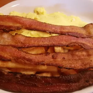 Two eggs scrambled with French fries &amp; bacon