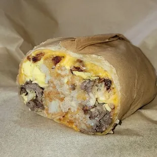 Country style burrito with tri tip half of thr sandwich