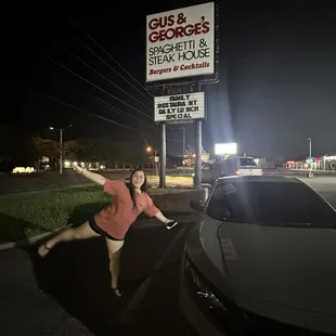 a woman leaning on a car
