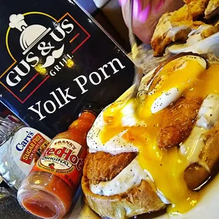 Yolk Porn Poached Eggs on top of Chicken Strips, Country Gravy and Waffle. The Country Waffle Deluxe OMG WOWED
