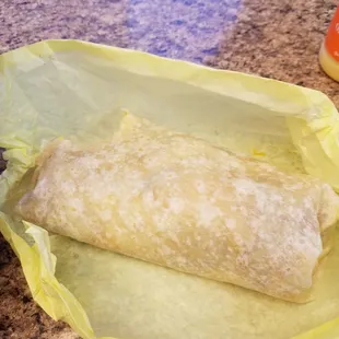 Breakfast burrito with bacon, eggs and hash brown.