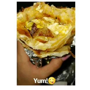 Egg, sausage, and bacon hashbrowns wrapped all around the inside extra cheese! The best out here I had yet hands down!