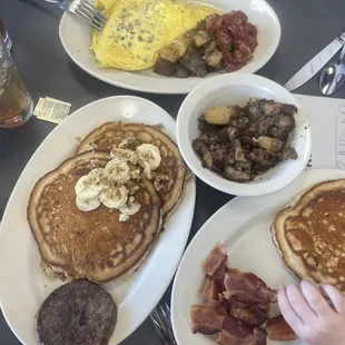 Pancakes, corned beef hash, bacon, omelette.