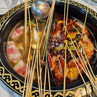 Assorted skewers in the broths