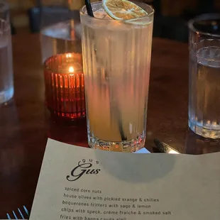 a drink on a table with a menu
