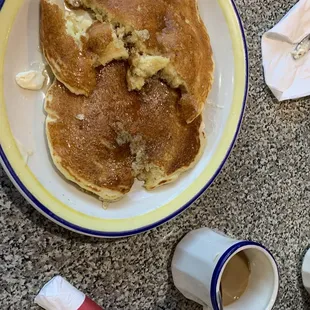 a plate of pancakes and a cup of coffee