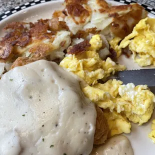 Chicken fried chicken with eggs and American fries