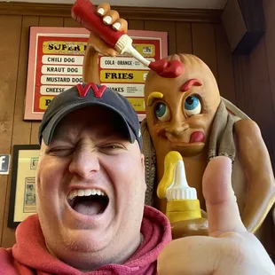 a man holding a bottle of mustard