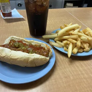 Hot dog with mustard, ketchup, relish and onion with fries and coke.