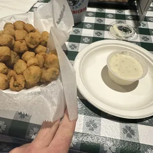 a plate of fried chicken nuggies and a bowl of ranched