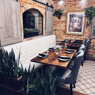 a dining room with a brick wall