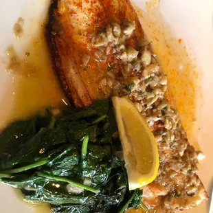 a plate of fish with spinach