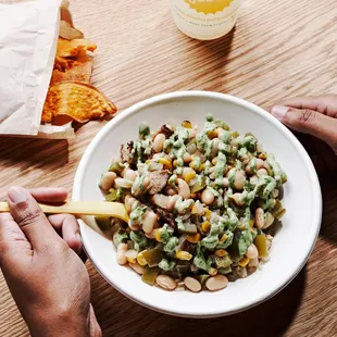 a person eating a bowl of food