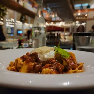 a plate of pasta with meat and cheese