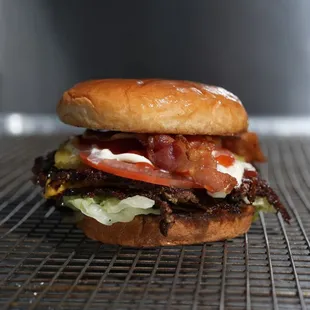 bacon, lettuce, tomato, and cheese on a bun