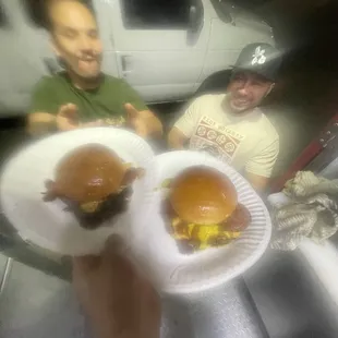 two men eating hamburgers