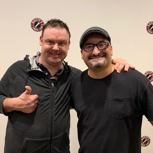 two men with thumbs up