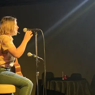 a woman singing into a microphone