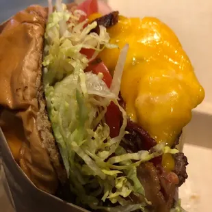 a hamburger with lettuce and cheese