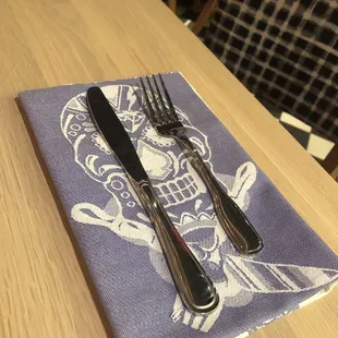 ows a fork and knife on a napkin