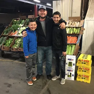 a man and two boys posing for a picture