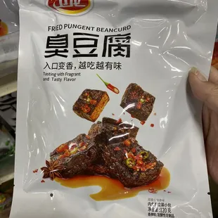 a hand holding a bag of food