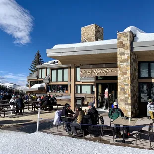 a group of people sitting outside a restaurant
