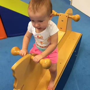 Zoey having fun on the rocking horse!!