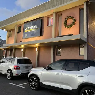 two cars parked in front of the restaurant